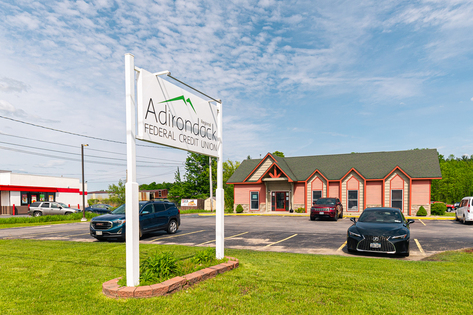 A view from the parking lot of our Potsdam credit union location. You can see the parking lot, and facility.