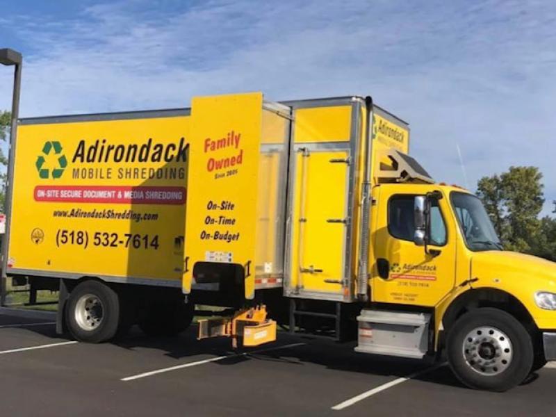 Large yellow document shredding truck from Adirondack Mobile Shredding